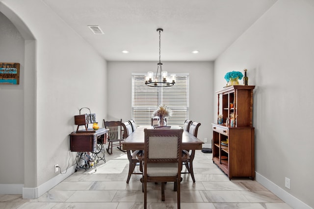 dining space with a chandelier