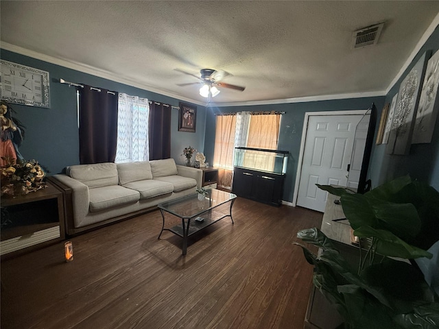 living room with visible vents, dark wood finished floors, ceiling fan, a textured ceiling, and crown molding