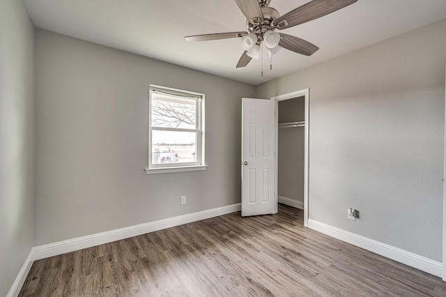 unfurnished bedroom with ceiling fan, light hardwood / wood-style floors, and a closet