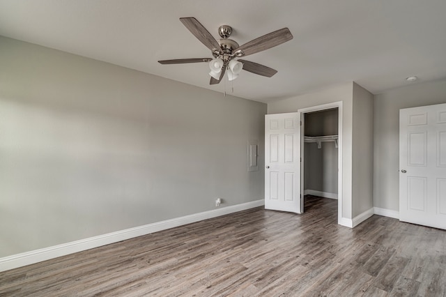 unfurnished bedroom with wood-type flooring, a closet, and ceiling fan