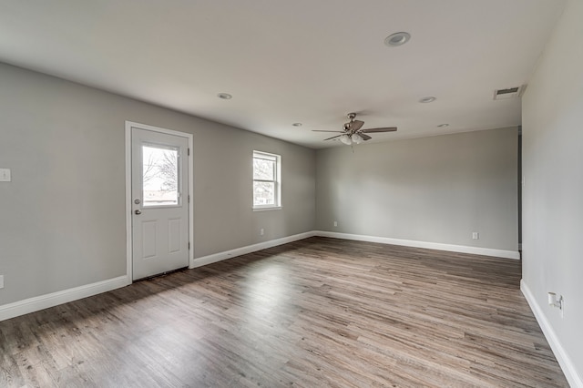 spare room with wood-type flooring and ceiling fan