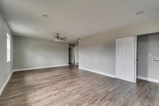 empty room with wood-type flooring and ceiling fan