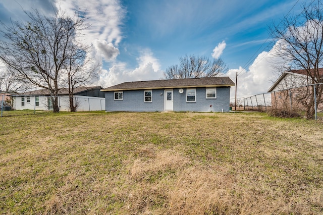 back of house with a lawn