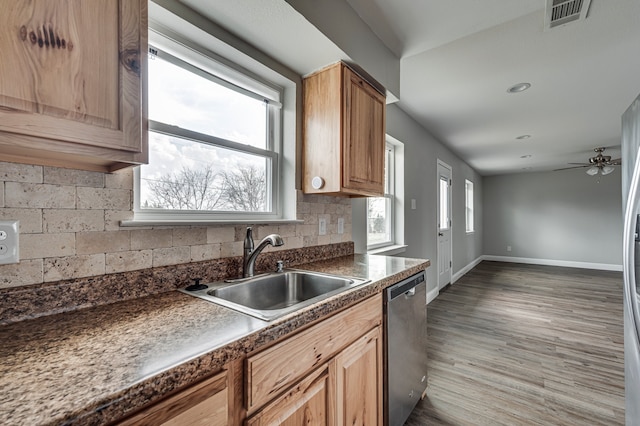 kitchen featuring dark hardwood / wood-style floors, tasteful backsplash, dishwasher, sink, and ceiling fan