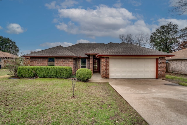 ranch-style house featuring a garage and a front lawn