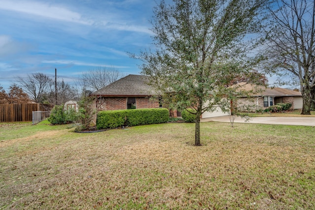 ranch-style house with a garage and a front yard