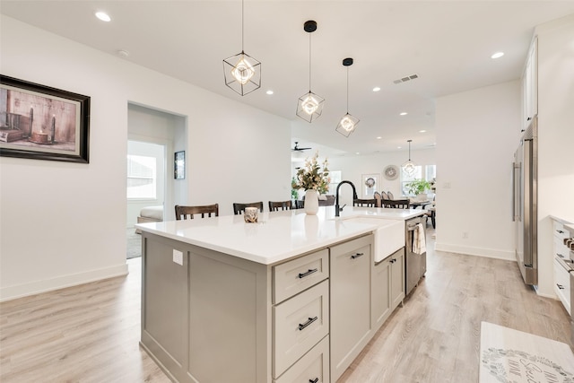 327 Lovers Ln, Terrell, TX 75160 - kitchen featuring a kitchen island with sink, appliances with stainless steel finishes, a sink, and light wood-style flooring