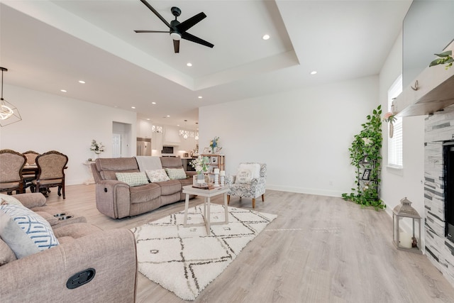 327 Lovers Ln, Terrell, TX 75160 - living room with a fireplace, light wood-style floors, baseboards, recessed lighting, and ceiling fan with notable chandelier