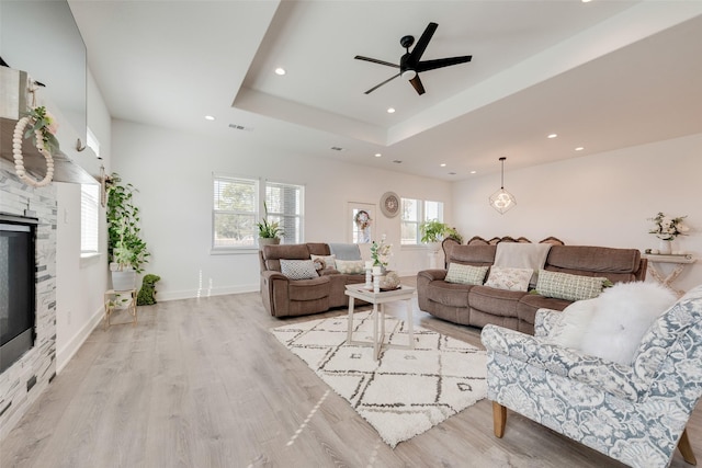 327 Lovers Ln, Terrell, TX 75160 - living room featuring a ceiling fan, a tray ceiling, recessed lighting, and light wood-style floors