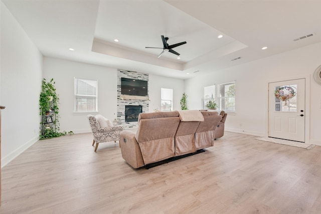 327 Lovers Ln, Terrell, TX 75160 - living area featuring visible vents, a ceiling fan, a tray ceiling, and light wood-type flooring