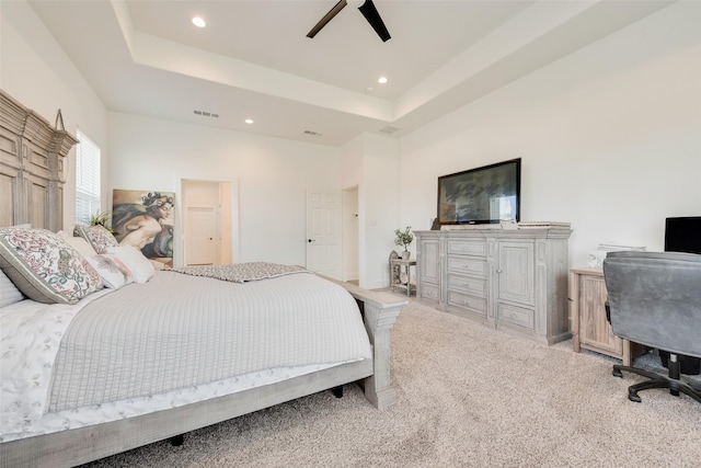 327 Lovers Ln, Terrell, TX 75160 - bedroom with visible vents, recessed lighting, a tray ceiling, and light carpet