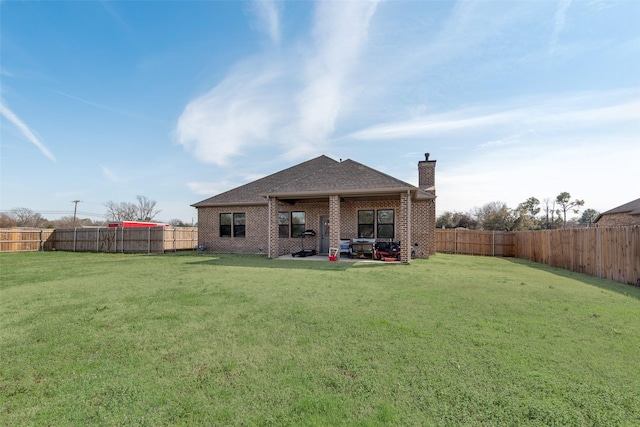 327 Lovers Ln, Terrell, TX 75160 - back of house with a yard, a patio, a chimney, and a fenced backyard
