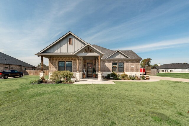 327 Lovers Ln, Terrell, TX 75160 - craftsman-style home with a chimney, brick siding, fence, a front lawn, and a shingled roof