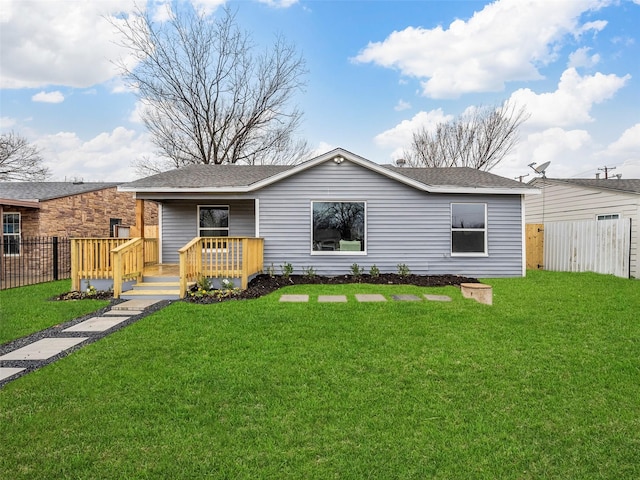 view of front of property featuring a front lawn and a deck