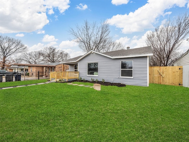 view of front of property featuring a wooden deck and a front lawn