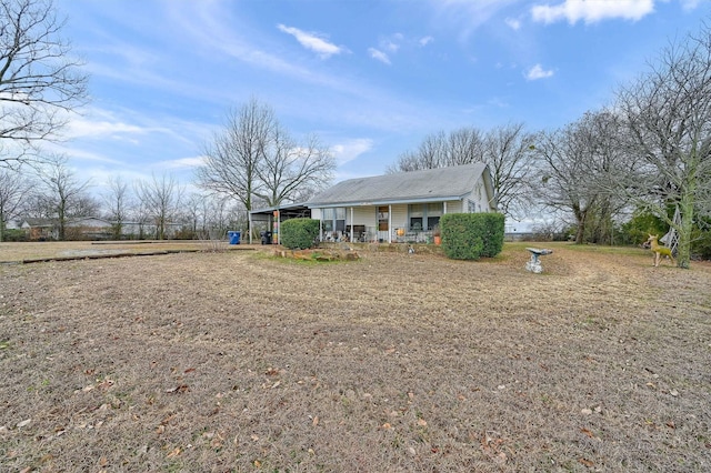 rear view of property with covered porch