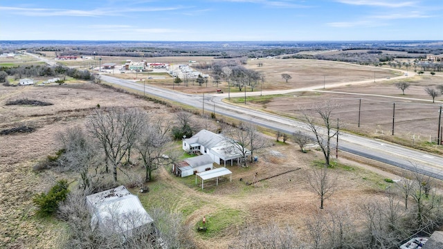 birds eye view of property with a rural view