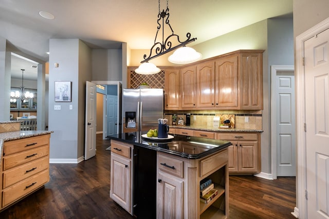 kitchen featuring hanging light fixtures, light brown cabinetry, dark stone counters, and stainless steel fridge with ice dispenser