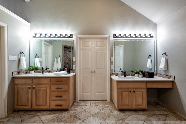 bathroom with lofted ceiling and vanity