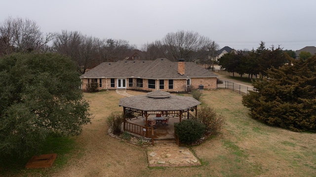 rear view of property with a yard