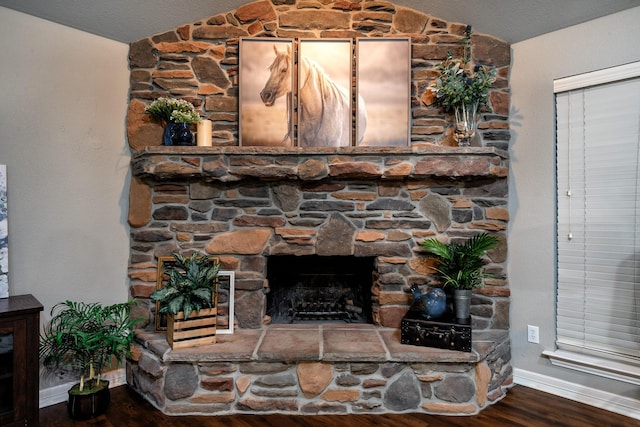 details with hardwood / wood-style flooring and a fireplace