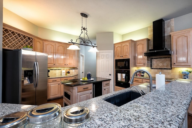 kitchen with a kitchen island, sink, dark stone counters, black appliances, and wall chimney exhaust hood