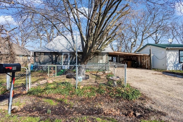 view of front of house with a carport and a sunroom