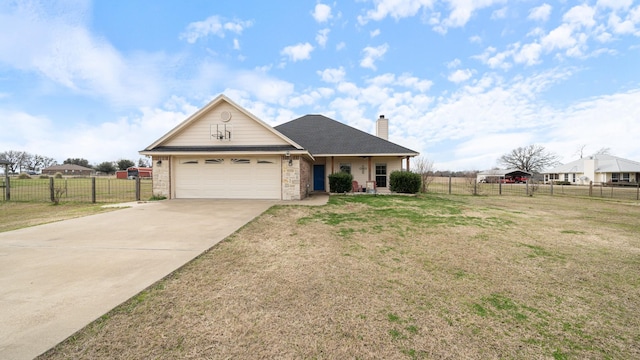 view of front of house with a garage and a front lawn