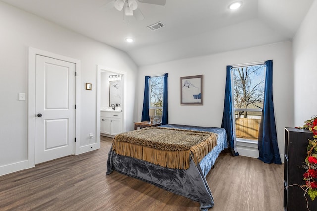 bedroom with sink, dark wood-type flooring, ceiling fan, ensuite bathroom, and vaulted ceiling