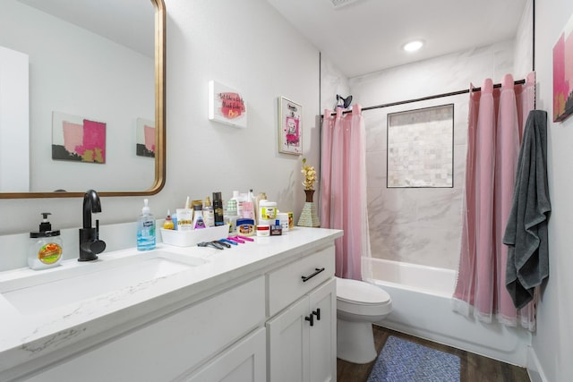 full bathroom with vanity, toilet, wood-type flooring, and shower / bath combo with shower curtain