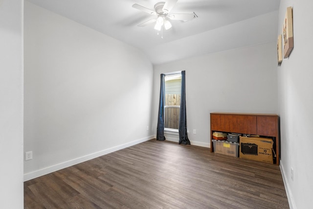 interior space with ceiling fan, lofted ceiling, and dark hardwood / wood-style flooring