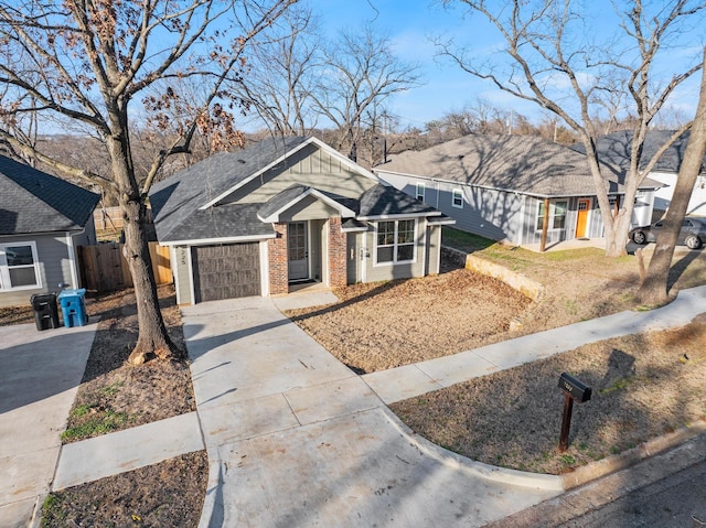 ranch-style house with fence, board and batten siding, concrete driveway, an attached garage, and brick siding