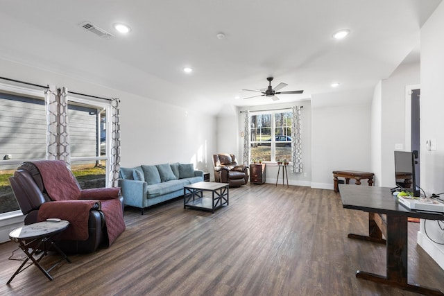 living room featuring ceiling fan and dark hardwood / wood-style floors