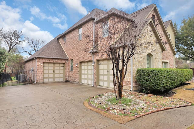 exterior space with central AC and a garage