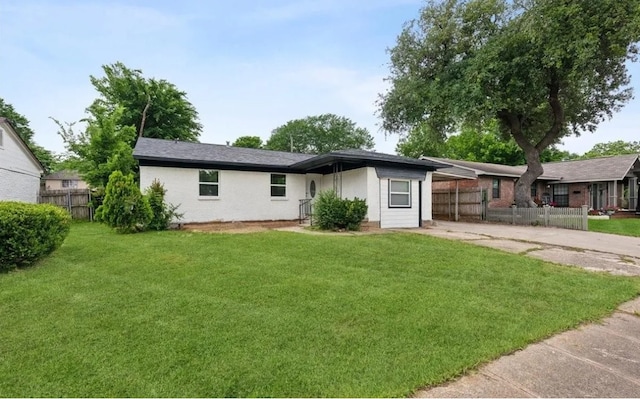 ranch-style home with a carport and a front lawn