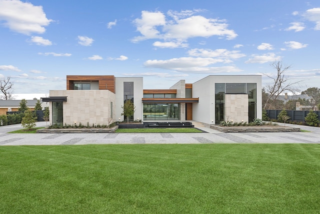 10335 Lennox Ln, Dallas, TX 75229 - view of front of house with a front lawn and fence