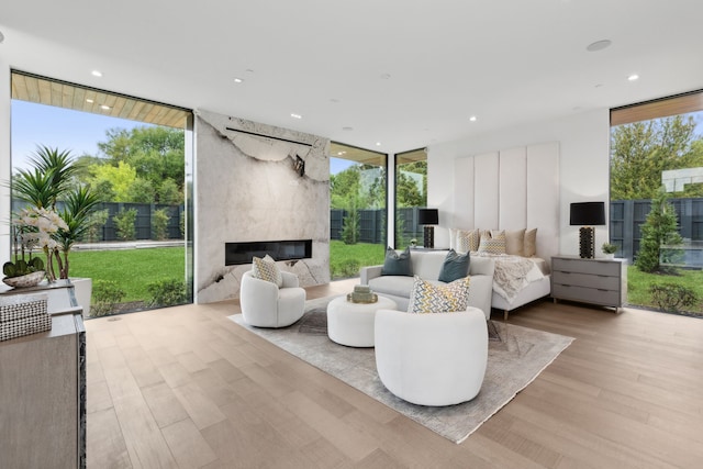 10335 Lennox Ln, Dallas, TX 75229 - living room featuring a premium fireplace, expansive windows, plenty of natural light, and wood finished floors