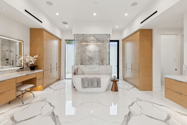 10335 Lennox Ln, Dallas, TX 75229 - bathroom with a marble finish shower, a freestanding bath, marble finish floor, vanity, and recessed lighting