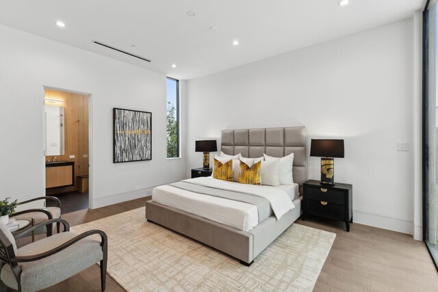 10335 Lennox Ln, Dallas, TX 75229 - bedroom with recessed lighting, ensuite bath, and wood finished floors