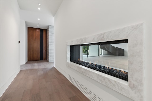 hallway with hardwood / wood-style flooring