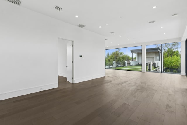 10335 Lennox Ln, Dallas, TX 75229 - empty room with visible vents, floor to ceiling windows, and wood finished floors