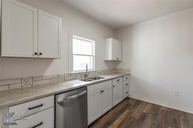 kitchen featuring sink, stainless steel dishwasher, dark hardwood / wood-style floors, and white cabinets