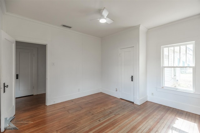 spare room with ornamental molding, light hardwood / wood-style floors, and ceiling fan