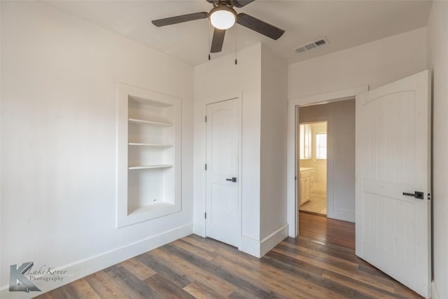 unfurnished bedroom with dark hardwood / wood-style floors and ceiling fan