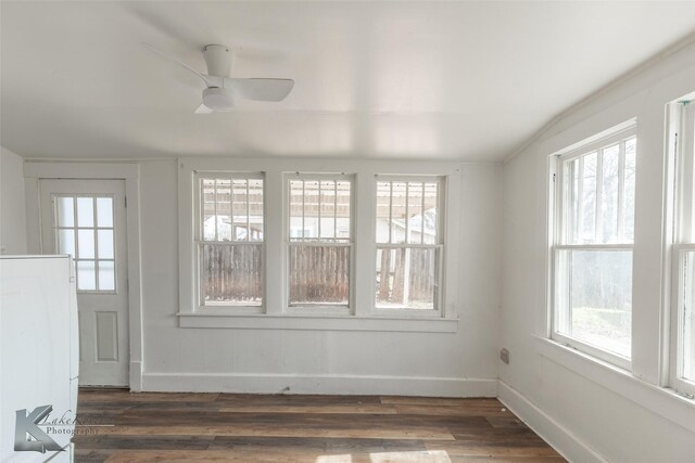 unfurnished sunroom featuring ceiling fan and a wealth of natural light