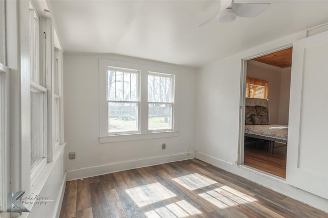 spare room with ceiling fan, lofted ceiling, and dark hardwood / wood-style flooring