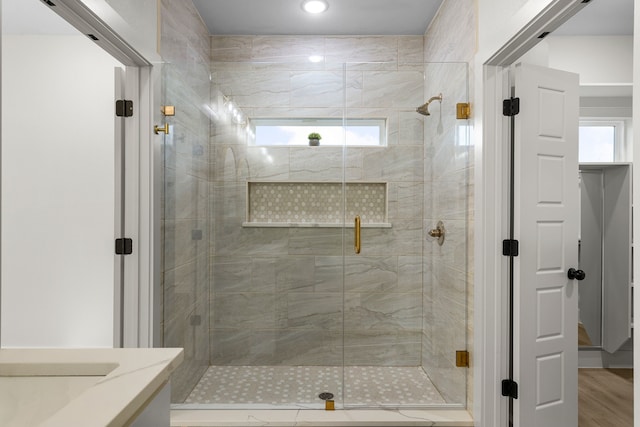 bathroom featuring an enclosed shower, vanity, hardwood / wood-style flooring, and plenty of natural light