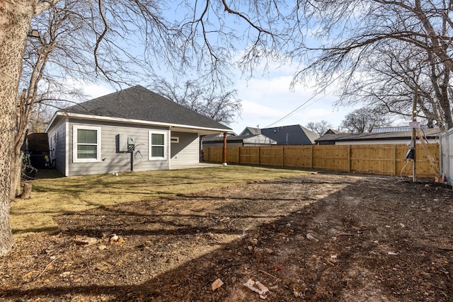 rear view of property featuring a lawn