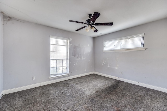 spare room with ceiling fan and carpet