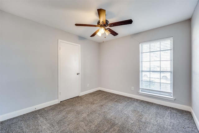 carpeted empty room featuring ceiling fan